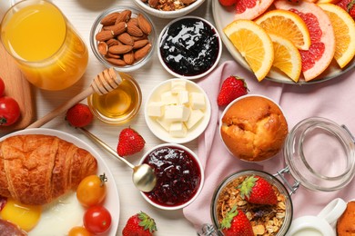 Photo of Different tasty food served for brunch on white wooden table, flat lay