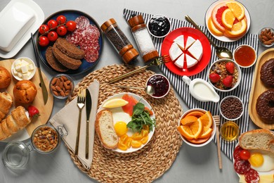 Photo of Different tasty food served for brunch on grey table, flat lay