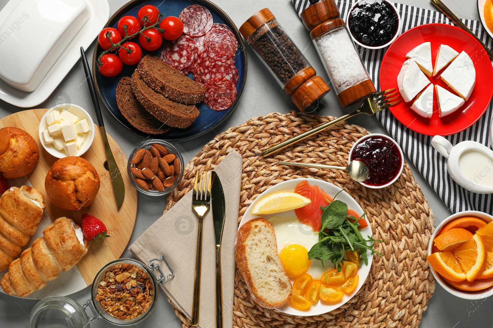 Photo of Different tasty food served for brunch on grey table, flat lay