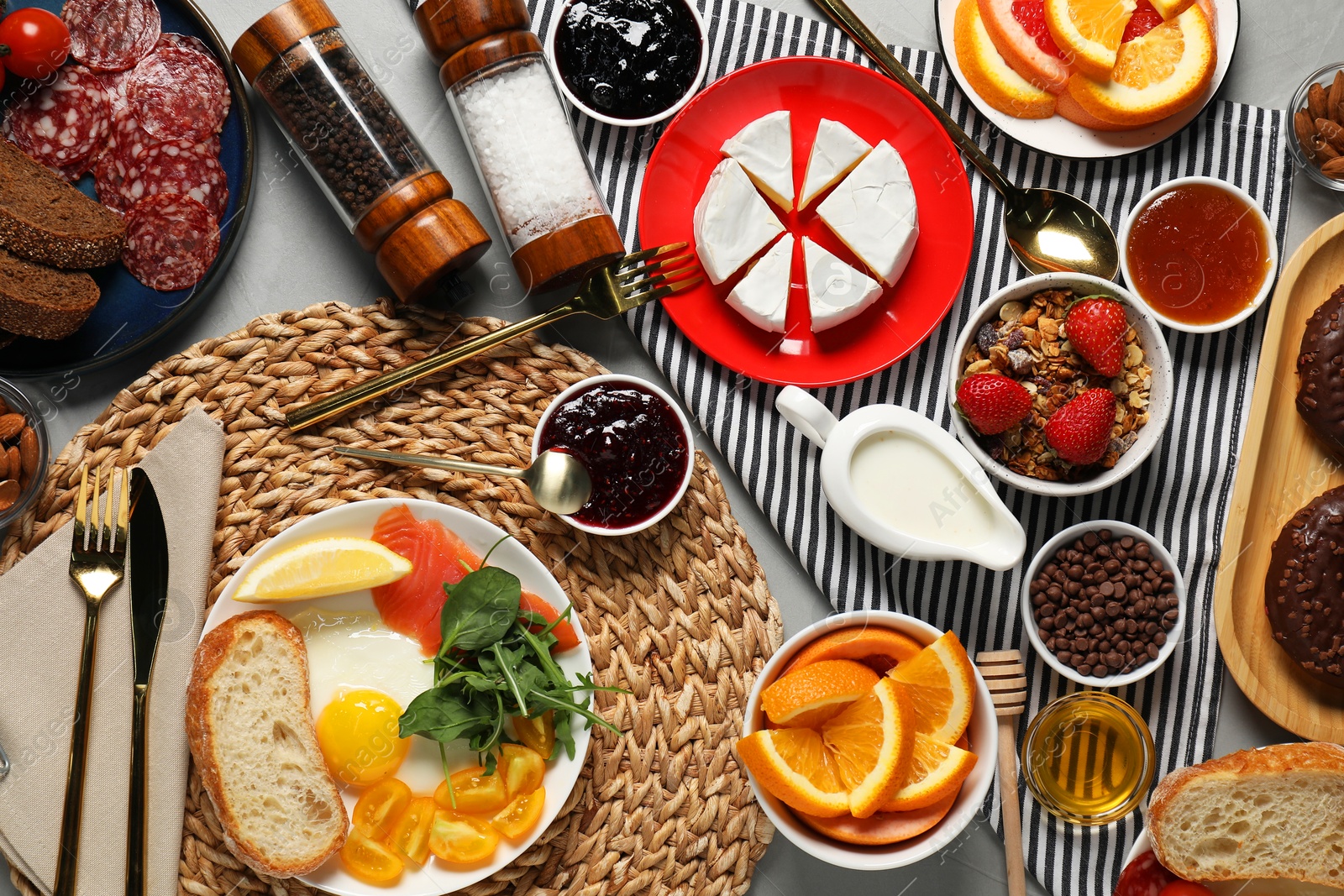 Photo of Different tasty food served for brunch on grey table, flat lay