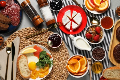 Different tasty food served for brunch on grey table, flat lay