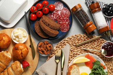 Photo of Different tasty food served for brunch on grey table, flat lay