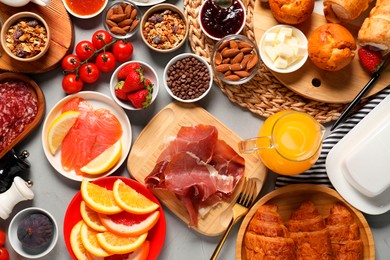 Photo of Different tasty food served for brunch on grey table, flat lay