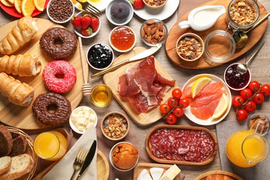 Photo of Different tasty food served for brunch on wooden table, flat lay