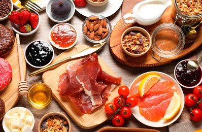 Photo of Different tasty food served for brunch on wooden table, flat lay