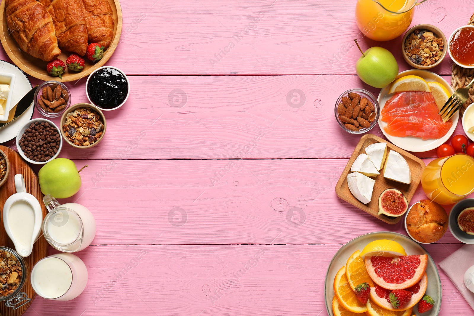 Photo of Different tasty food served for brunch on pink wooden table, flat lay. Space for text