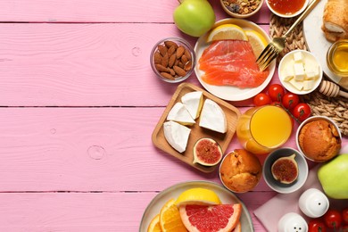 Photo of Different tasty food served for brunch on pink wooden table, flat lay. Space for text