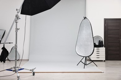 Photo of Professional lighting equipment setup in modern photo studio