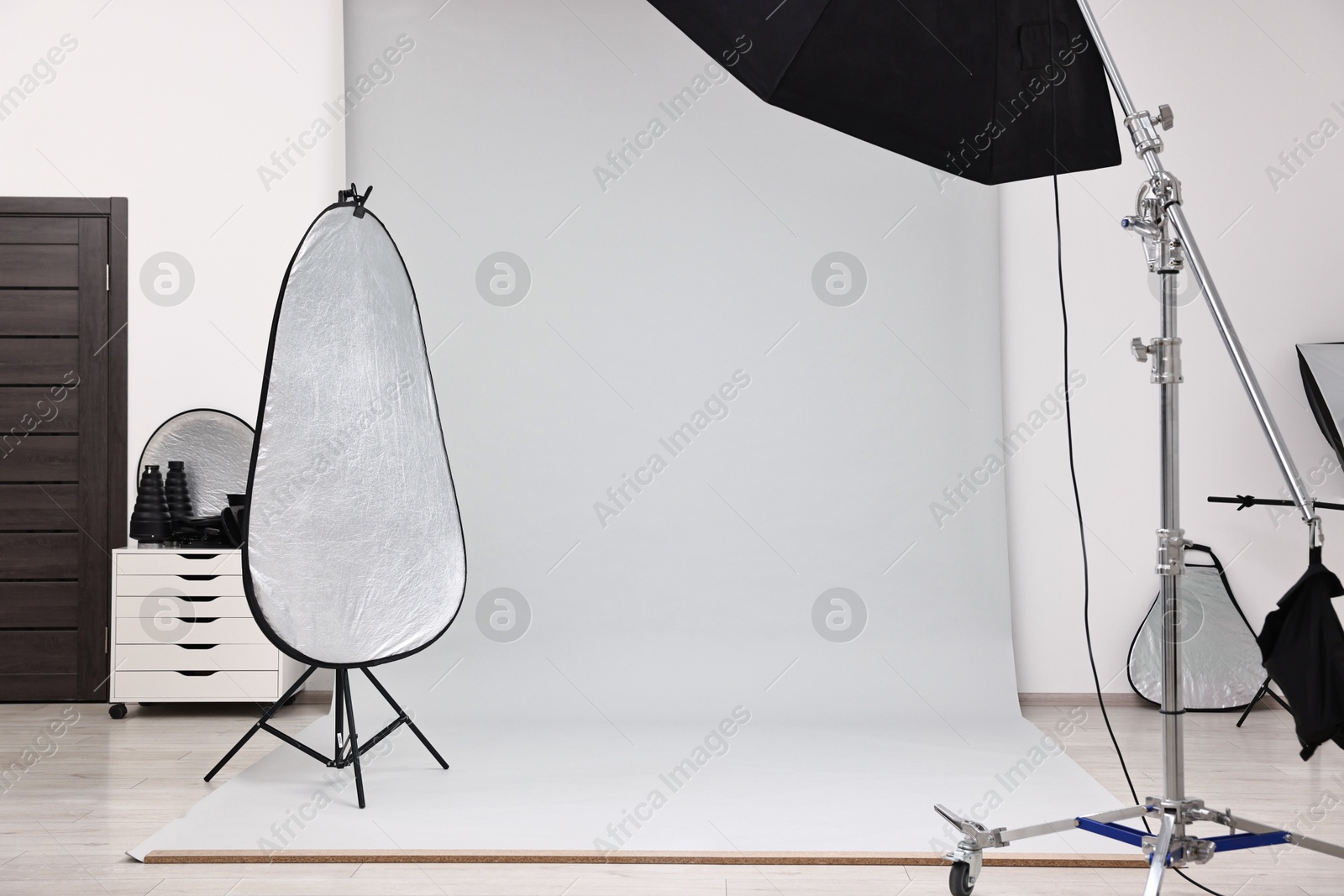 Photo of Professional lighting equipment setup in modern photo studio