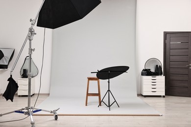 Photo of Professional lighting equipment setup in modern photo studio