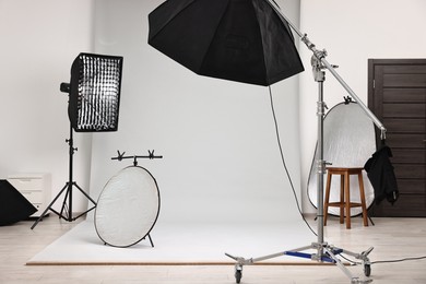 Photo of Professional lighting equipment setup in modern photo studio