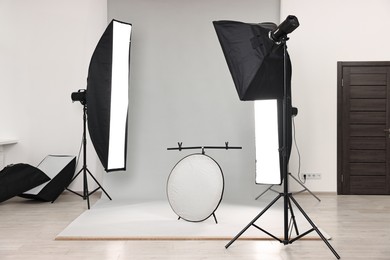 Photo of Professional lighting equipment setup in modern photo studio