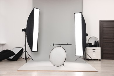 Photo of Professional lighting equipment setup in modern photo studio