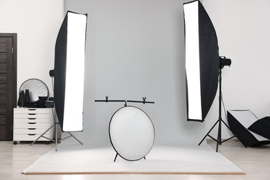 Photo of Professional lighting equipment setup in modern photo studio