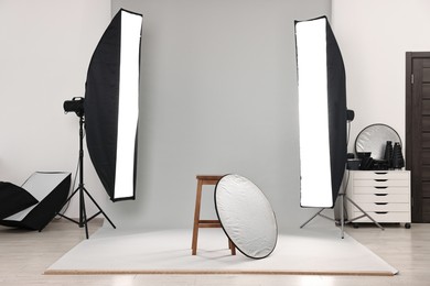 Photo of Professional lighting equipment setup in modern photo studio