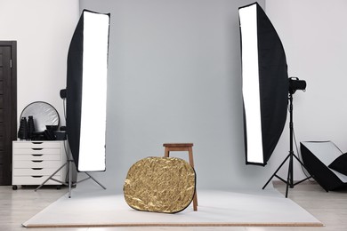 Professional lighting equipment setup in modern photo studio