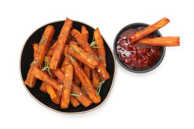 Photo of Delicious sweet potato fries with spices and sauce isolated on white, top view