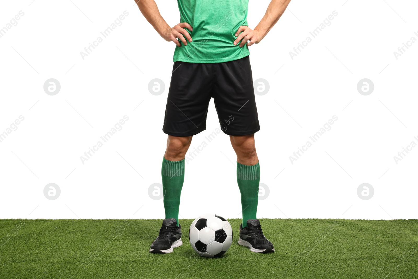 Photo of Football player and soccer ball on artificial grass against white background, closeup