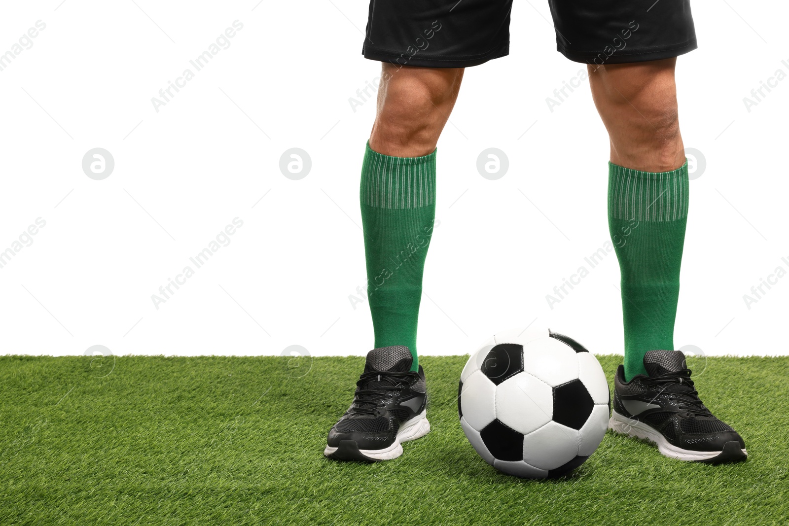 Photo of Football player and soccer ball on artificial grass against white background, closeup