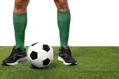 Photo of Football player and soccer ball on artificial grass against white background, closeup