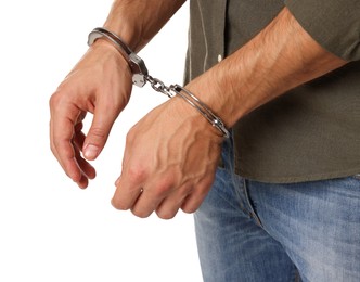 Photo of Man in metal handcuffs on white background, closeup