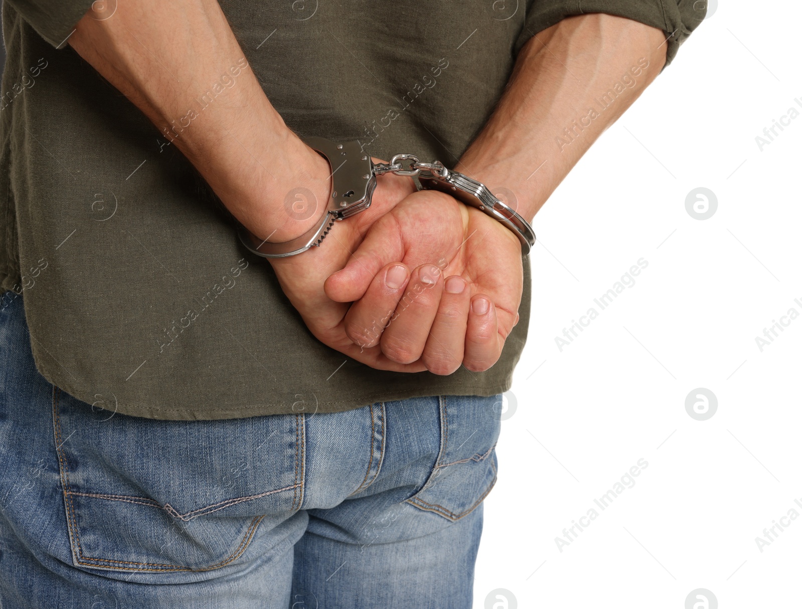 Photo of Man in metal handcuffs on white background, back view