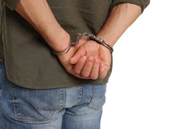 Photo of Man in metal handcuffs on white background, back view