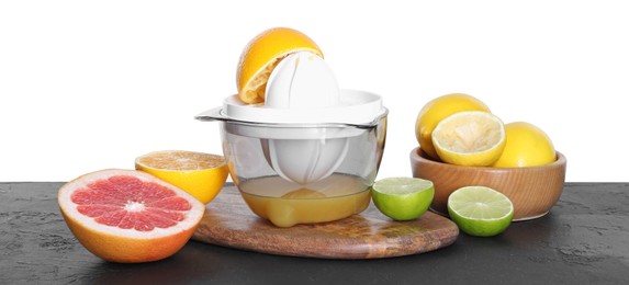 Photo of Plastic juicer and different fresh citrus fruits on black table against white background