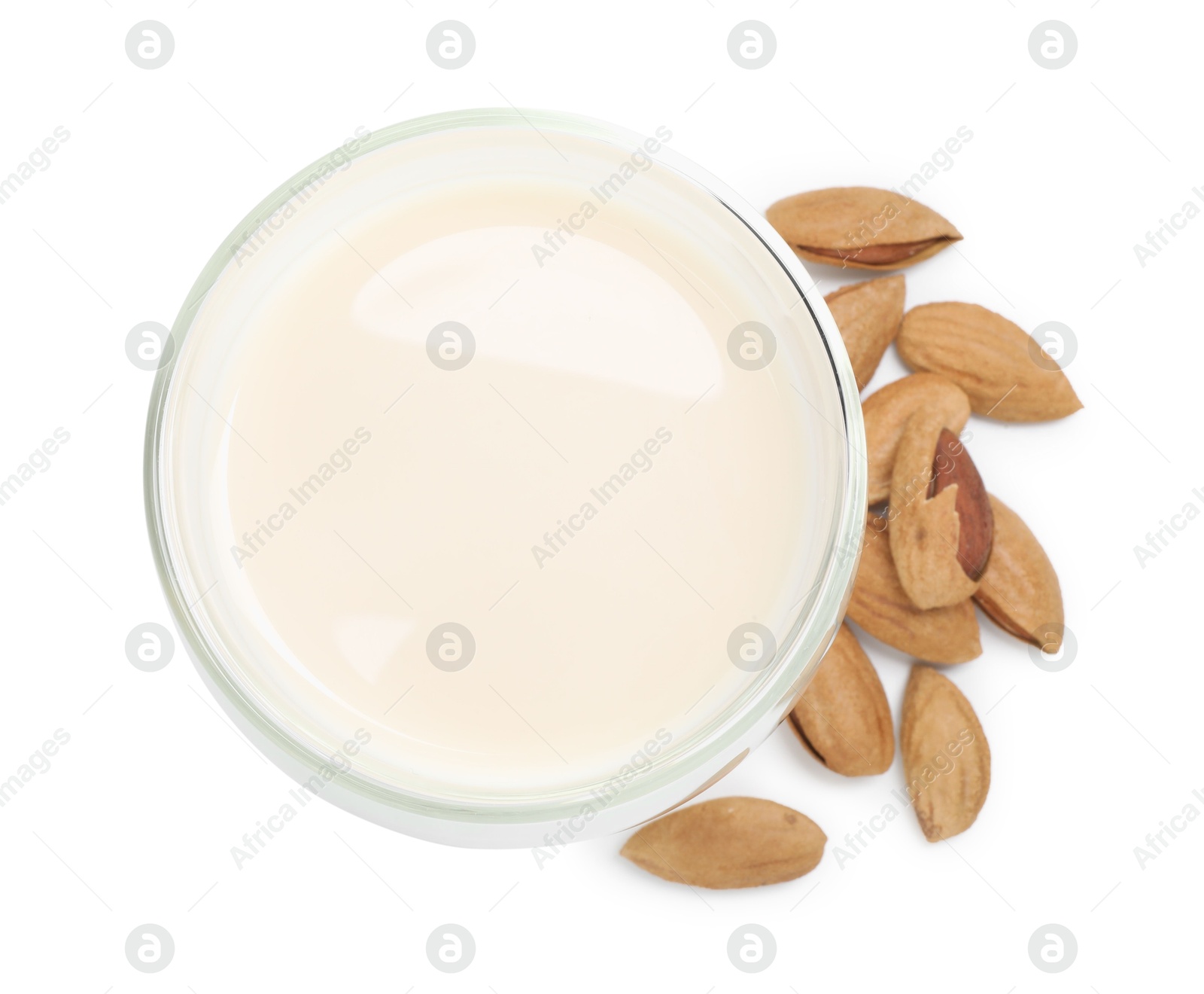 Photo of Glass of almond milk and nuts isolated on white, top view