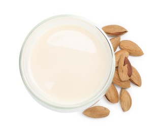 Glass of almond milk and nuts isolated on white, top view