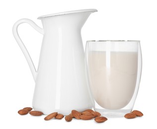 Photo of Glass and jug of almond milk and nuts isolated on white