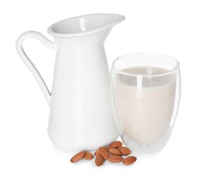 Photo of Glass and jug of almond milk and nuts isolated on white