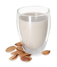 Photo of Glass of almond milk and nuts isolated on white