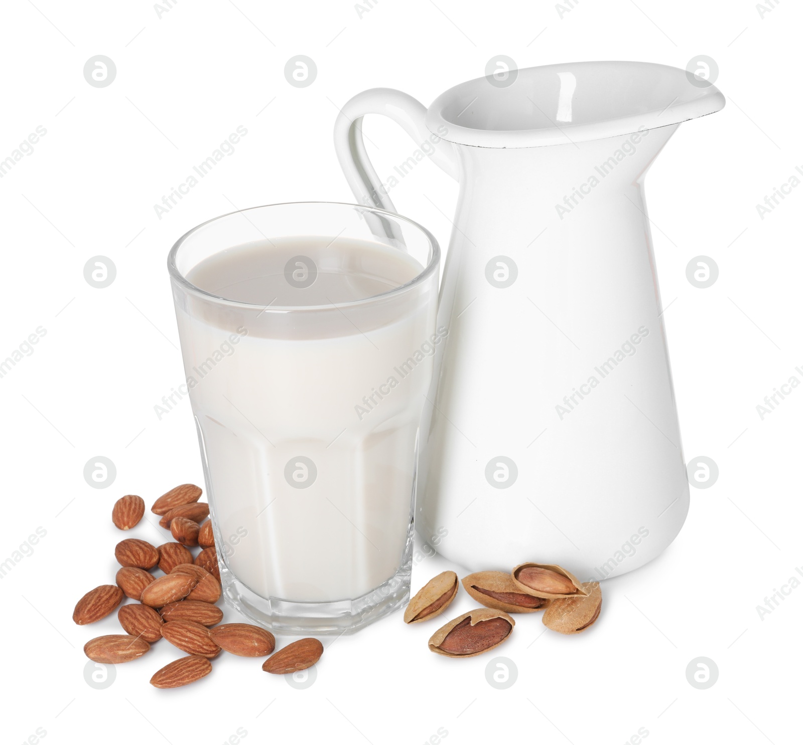 Photo of Glass and jug of almond milk and nuts isolated on white