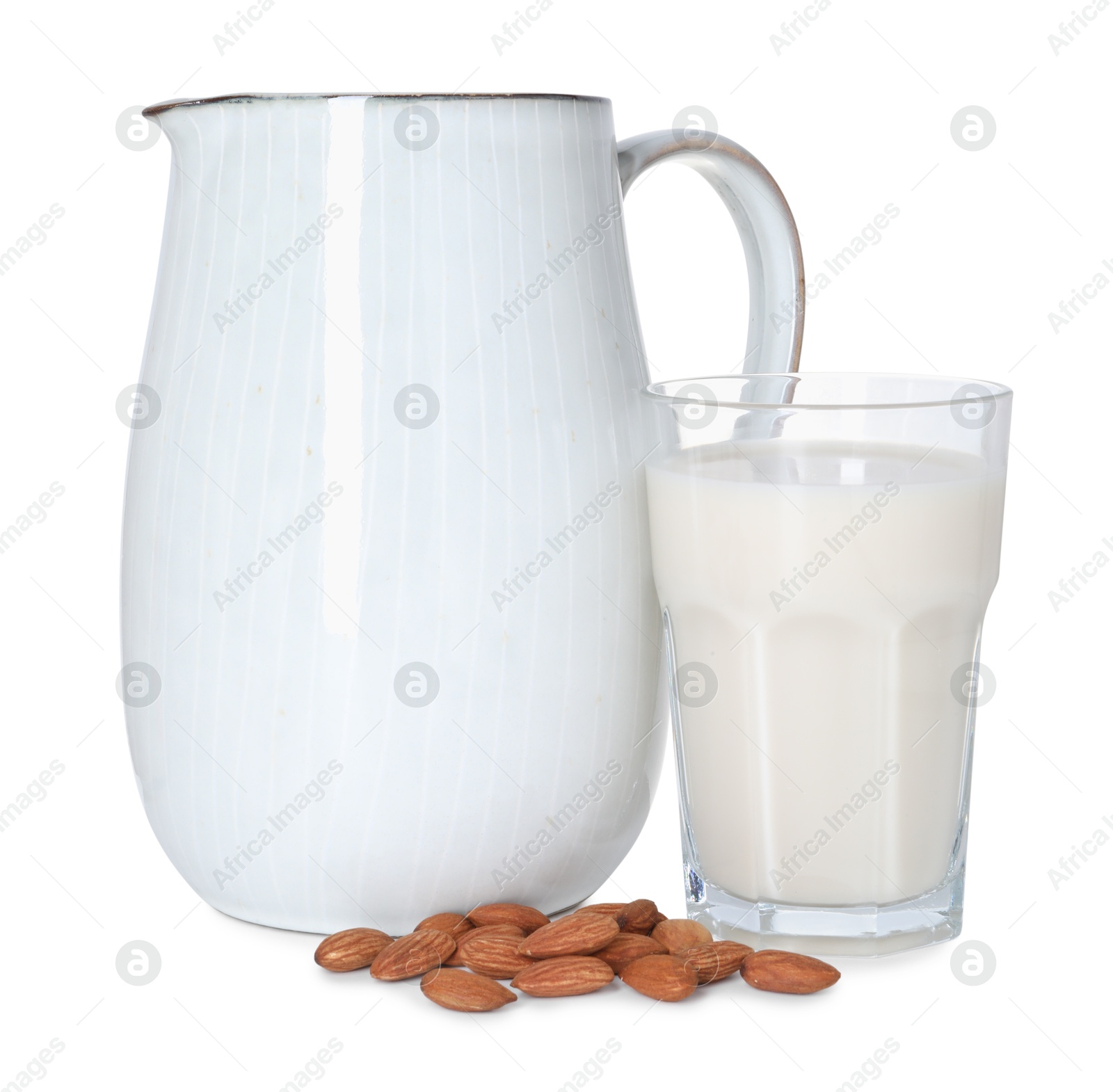 Photo of Glass and jug of almond milk and nuts isolated on white