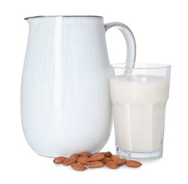 Photo of Glass and jug of almond milk and nuts isolated on white