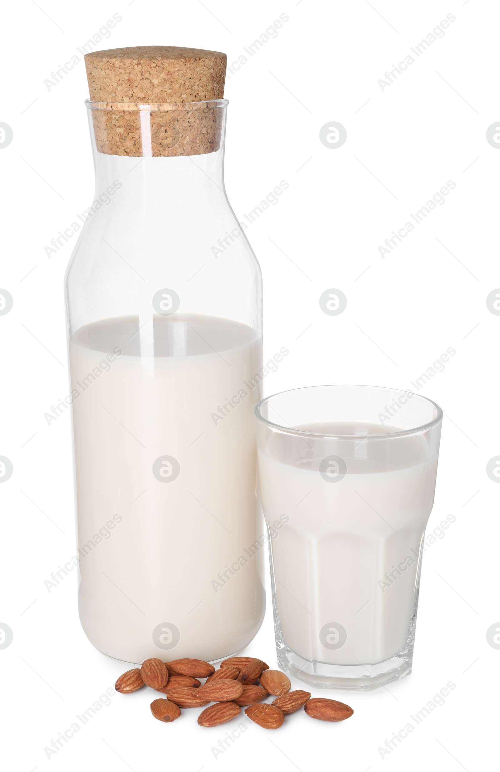 Photo of Glass and bottle of almond milk and nuts isolated on white