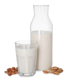 Photo of Glass and bottle of almond milk and nuts isolated on white