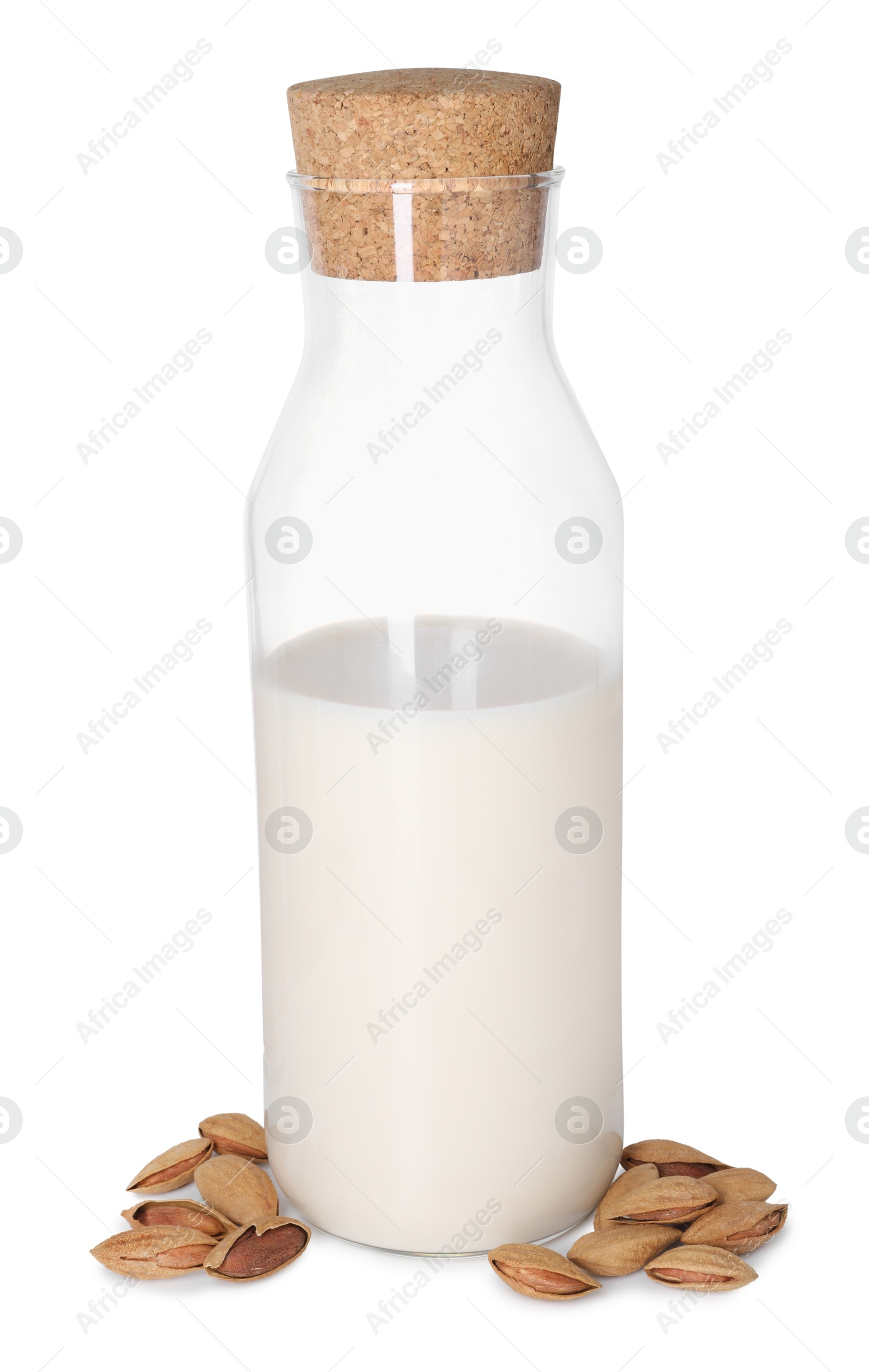 Photo of Glass and bottle of almond milk and nuts isolated on white