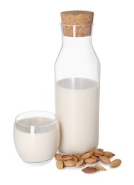 Photo of Glass and bottle of almond milk and nuts isolated on white