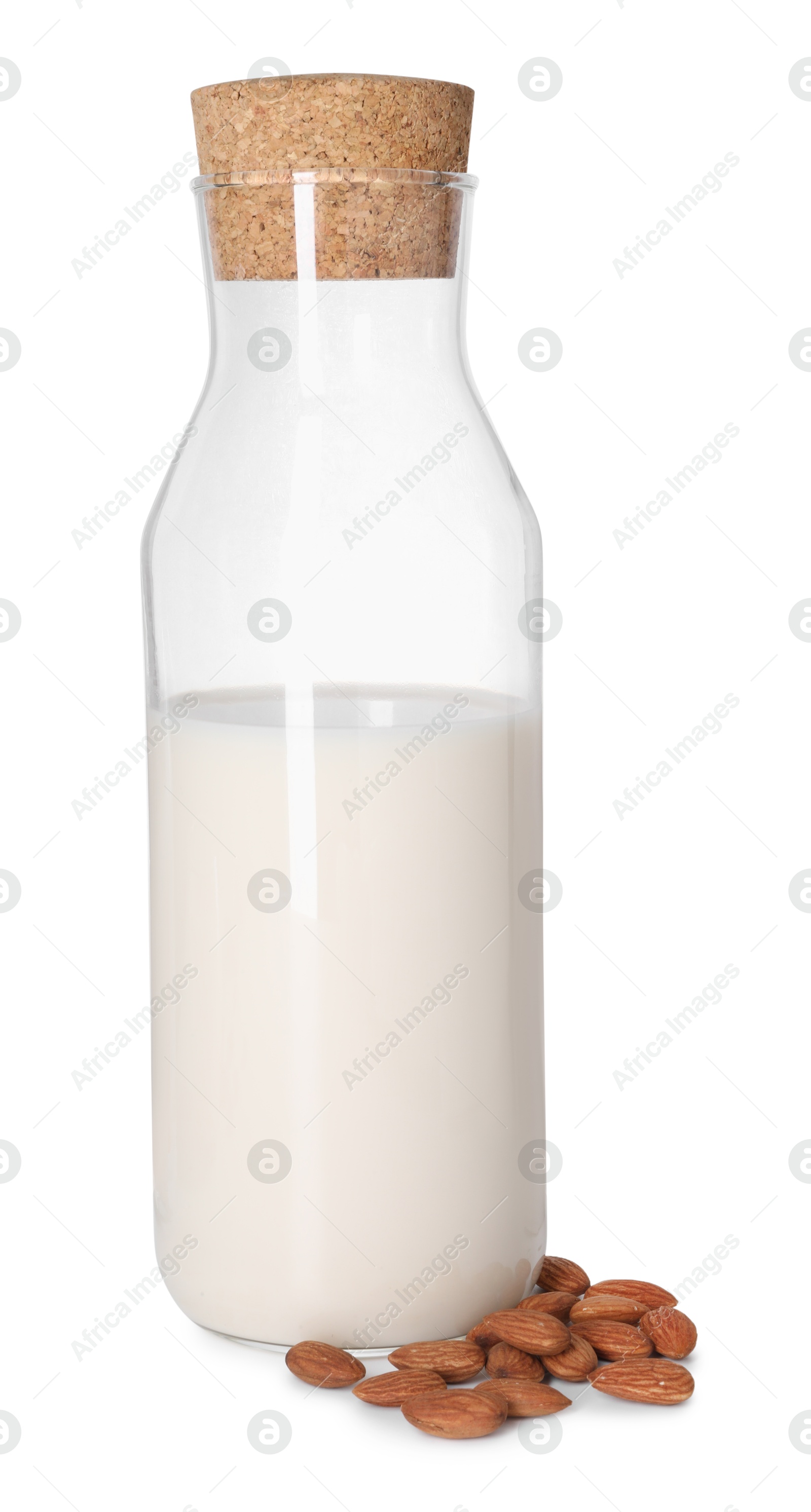 Photo of Bottle of almond milk and nuts isolated on white