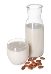 Glass and bottle of almond milk and nuts isolated on white