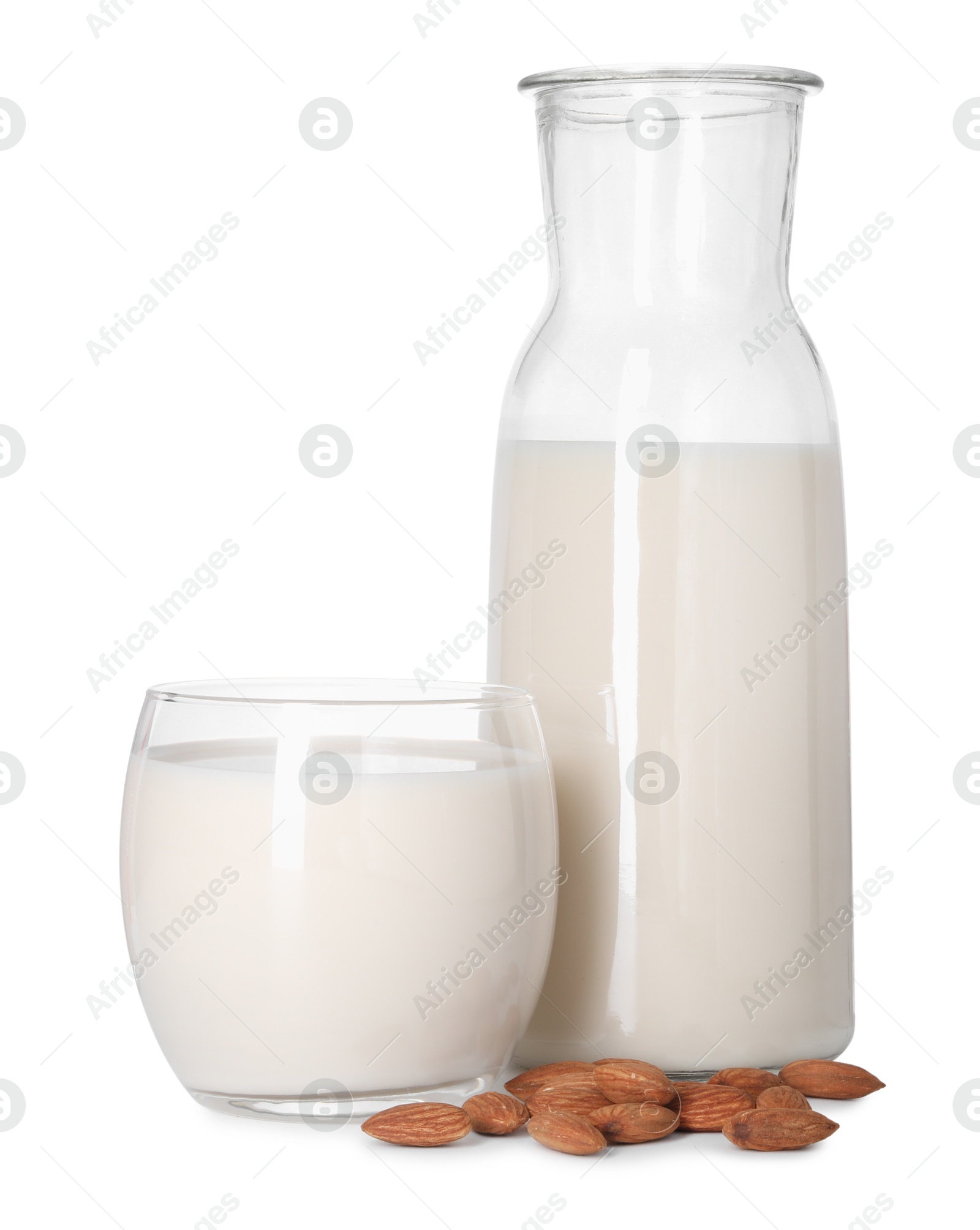 Photo of Glass and bottle of almond milk and nuts isolated on white