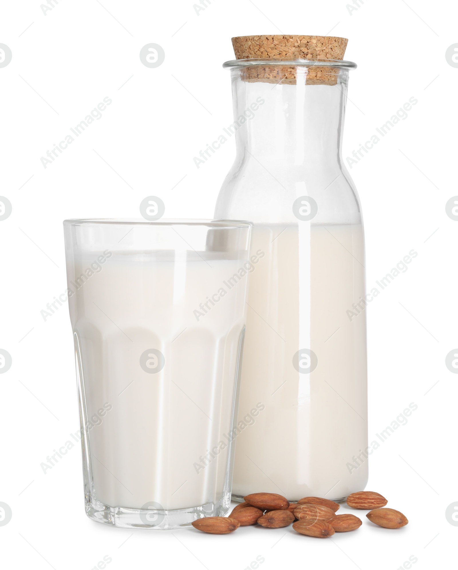 Photo of Glass and bottle of almond milk and nuts isolated on white