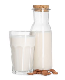 Glass and bottle of almond milk and nuts isolated on white