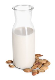 Photo of Bottle of almond milk and nuts isolated on white