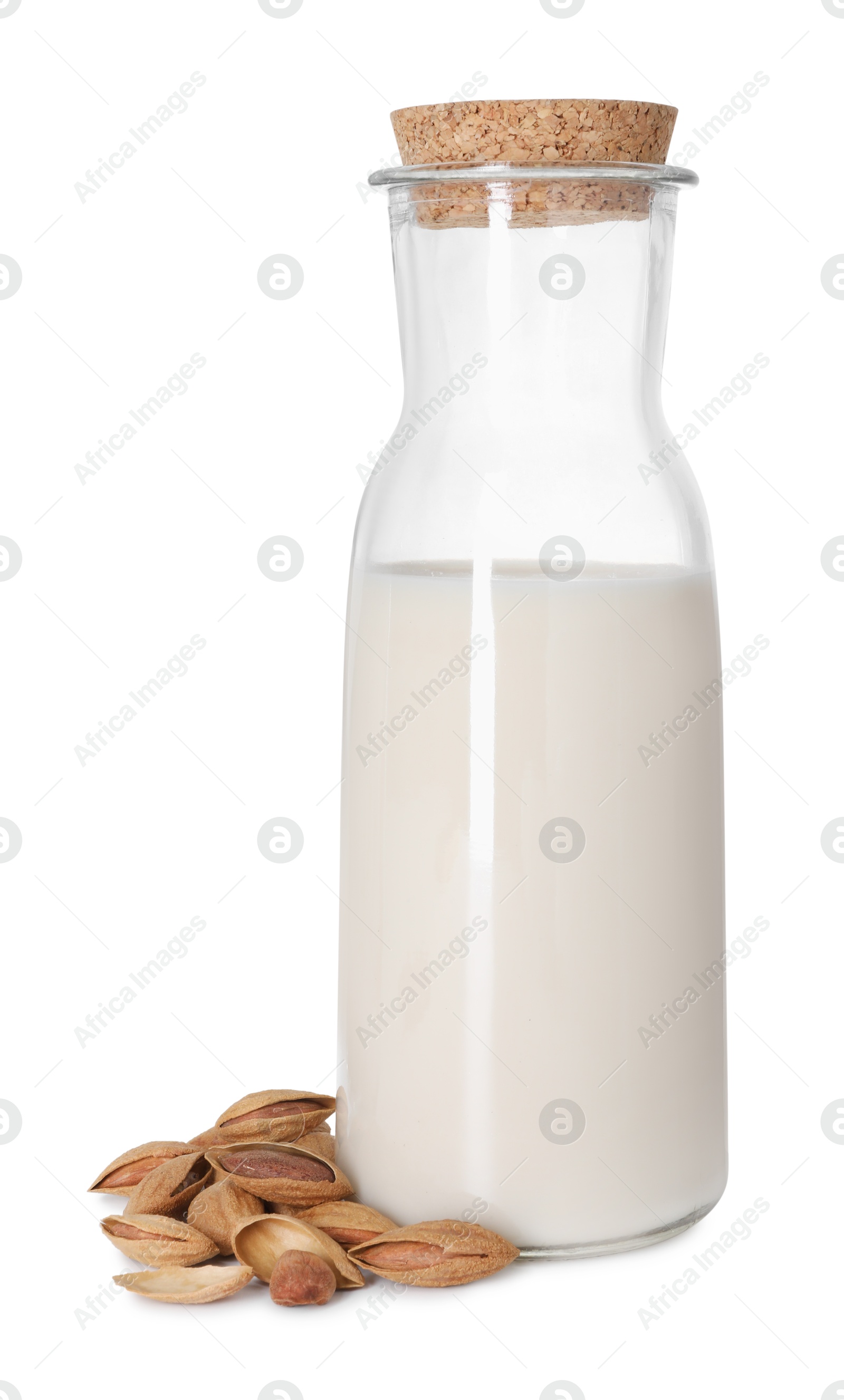 Photo of Bottle of almond milk and nuts isolated on white