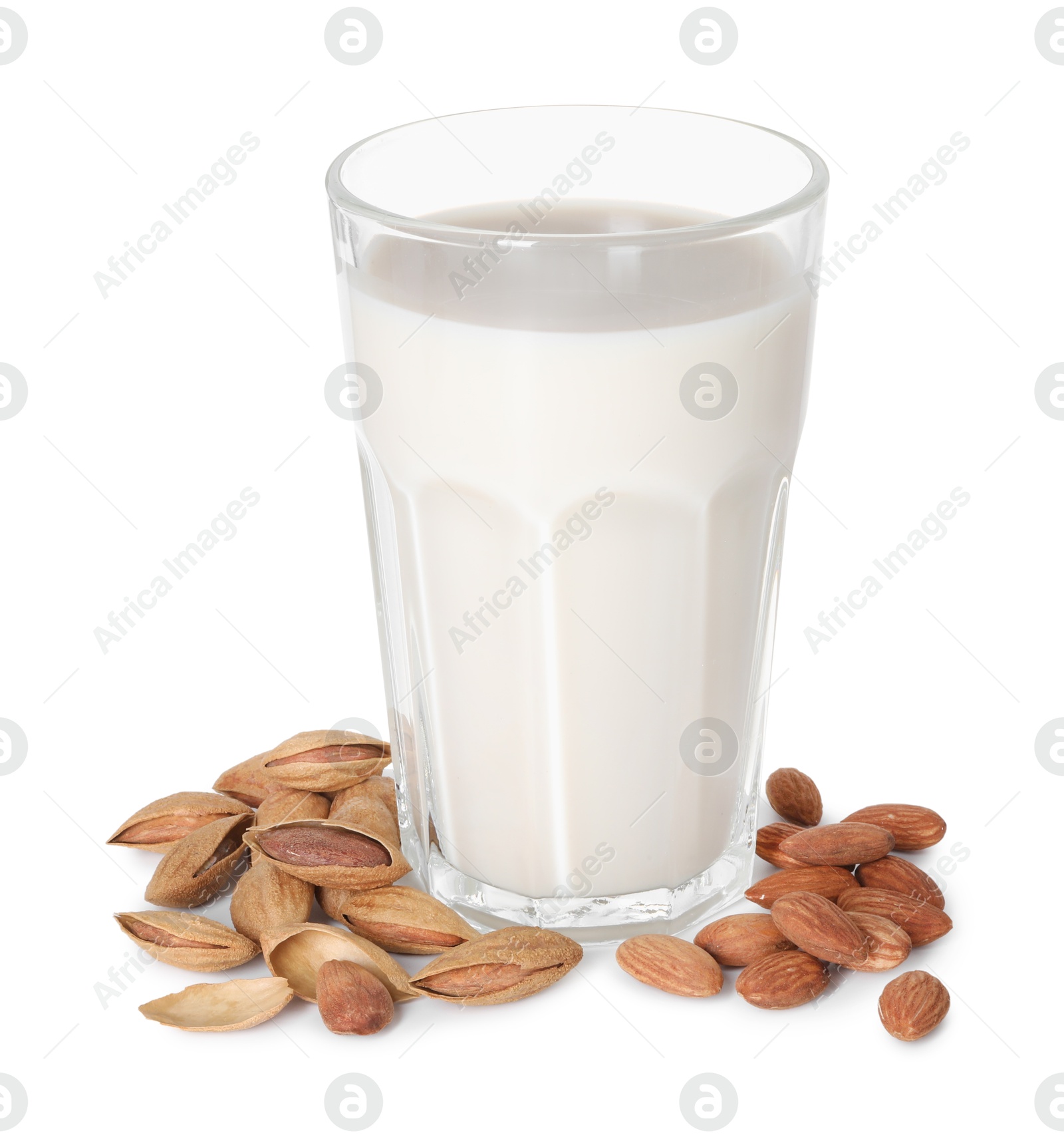 Photo of Glass of almond milk and nuts isolated on white