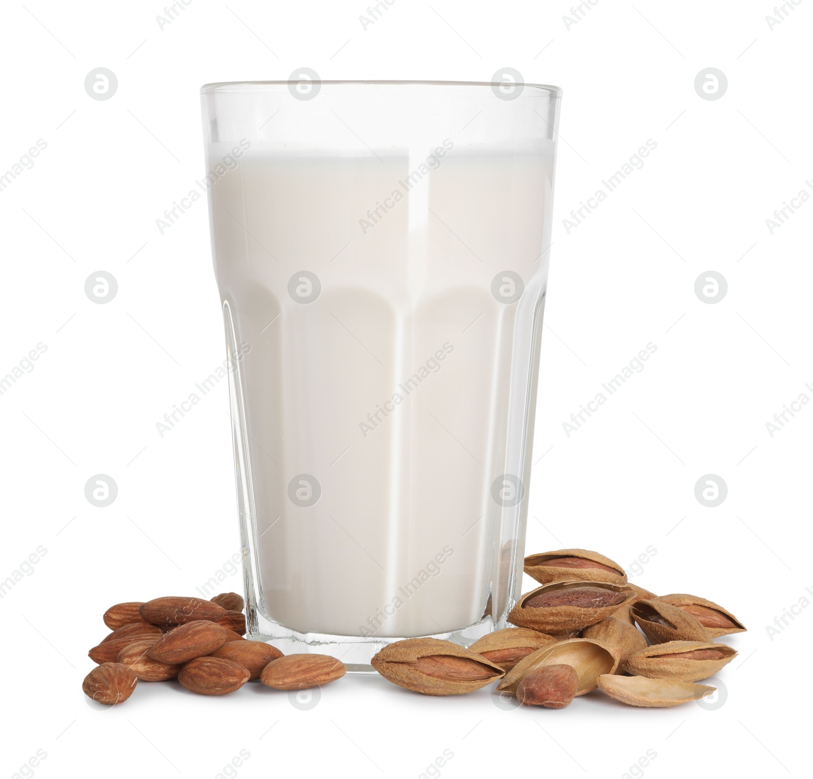 Photo of Glass of almond milk and nuts isolated on white