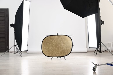 Photo of Professional lighting equipment setup in modern photo studio